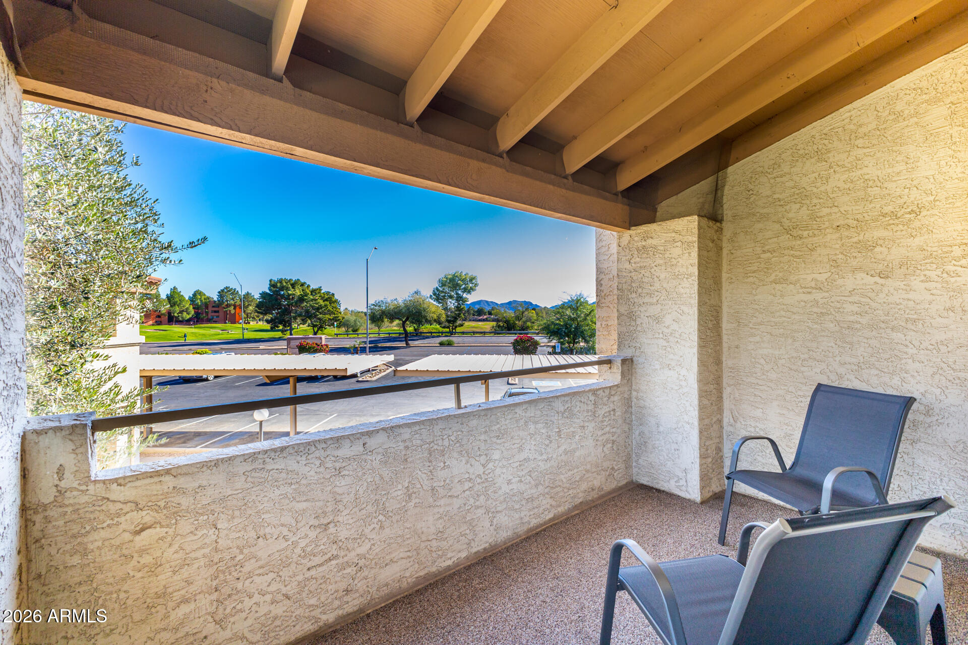 4150 East Cactus Road, Unit 210 Phoenix, AZ 85032 - Photo 36 of 45 a view of a chair and tables in the balcony