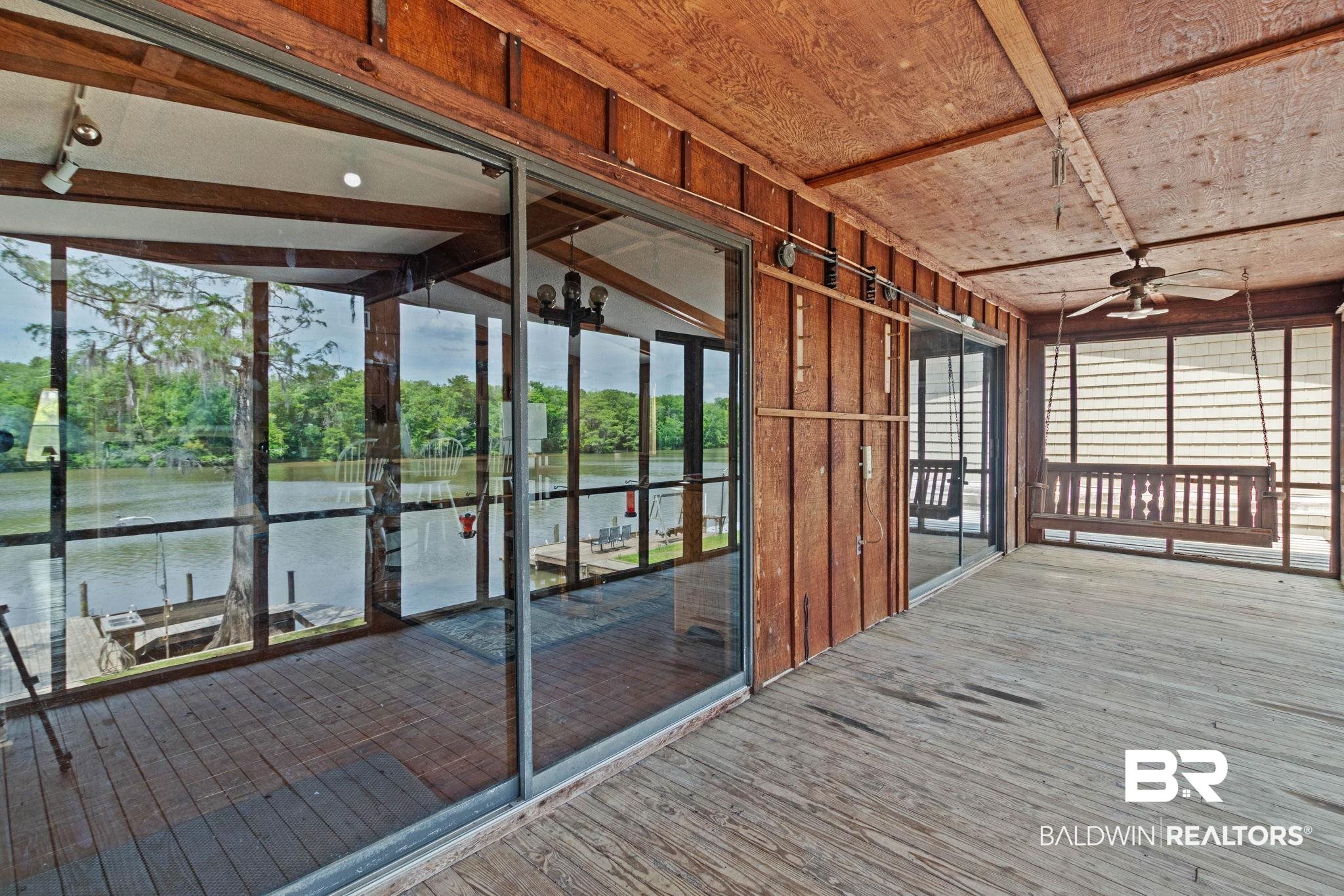 8153 Bryant's Lndg Road Stockton, AL 36579 - Photo 63 of 87 Enclosed porch with wood-finish flooring and ceiling, featuring panoramic water scenery with mature trees