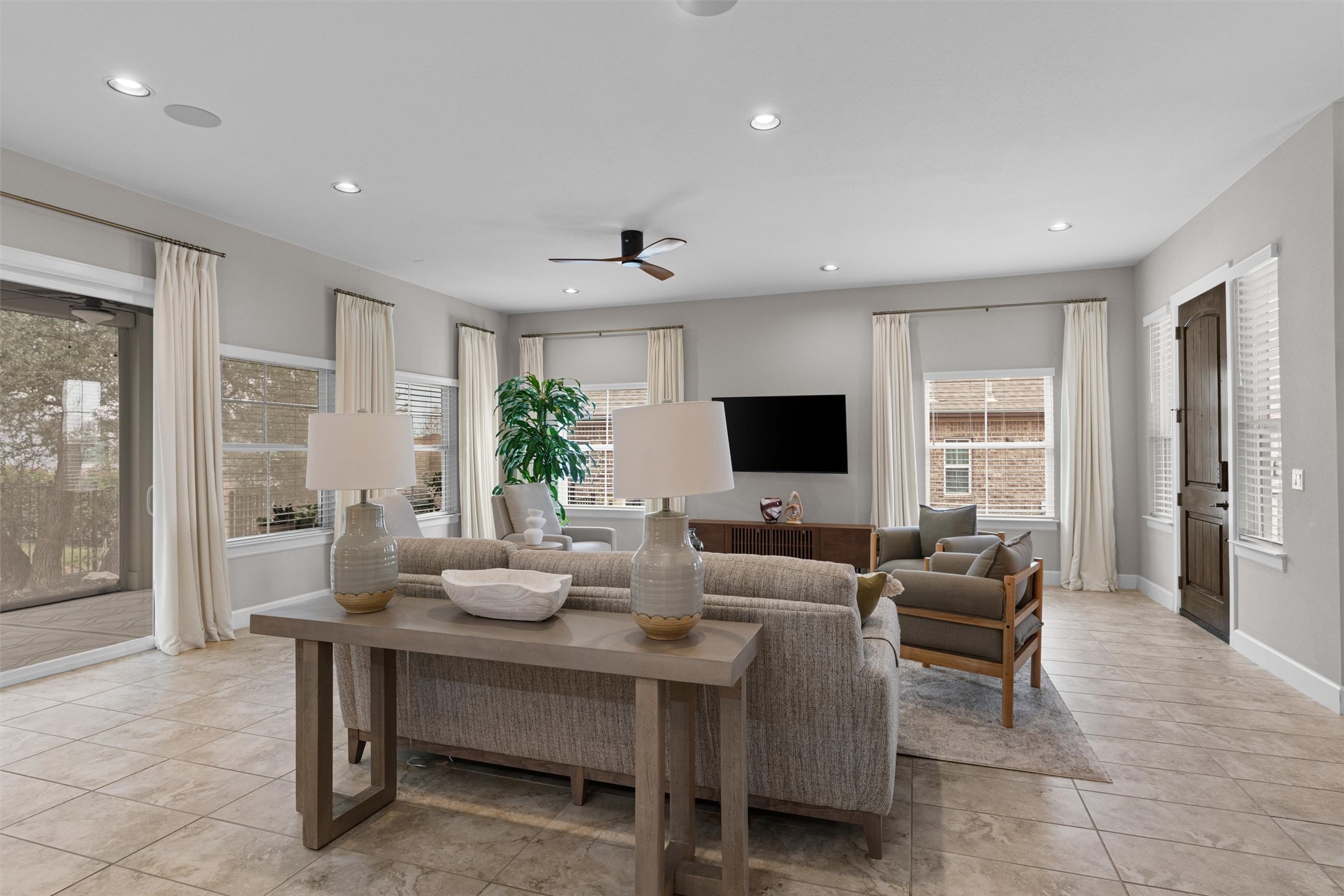 313 Racing Oak Loop San Marcos, TX 78666 - Photo 11 of 39 a living room with furniture a large window and a flat screen tv