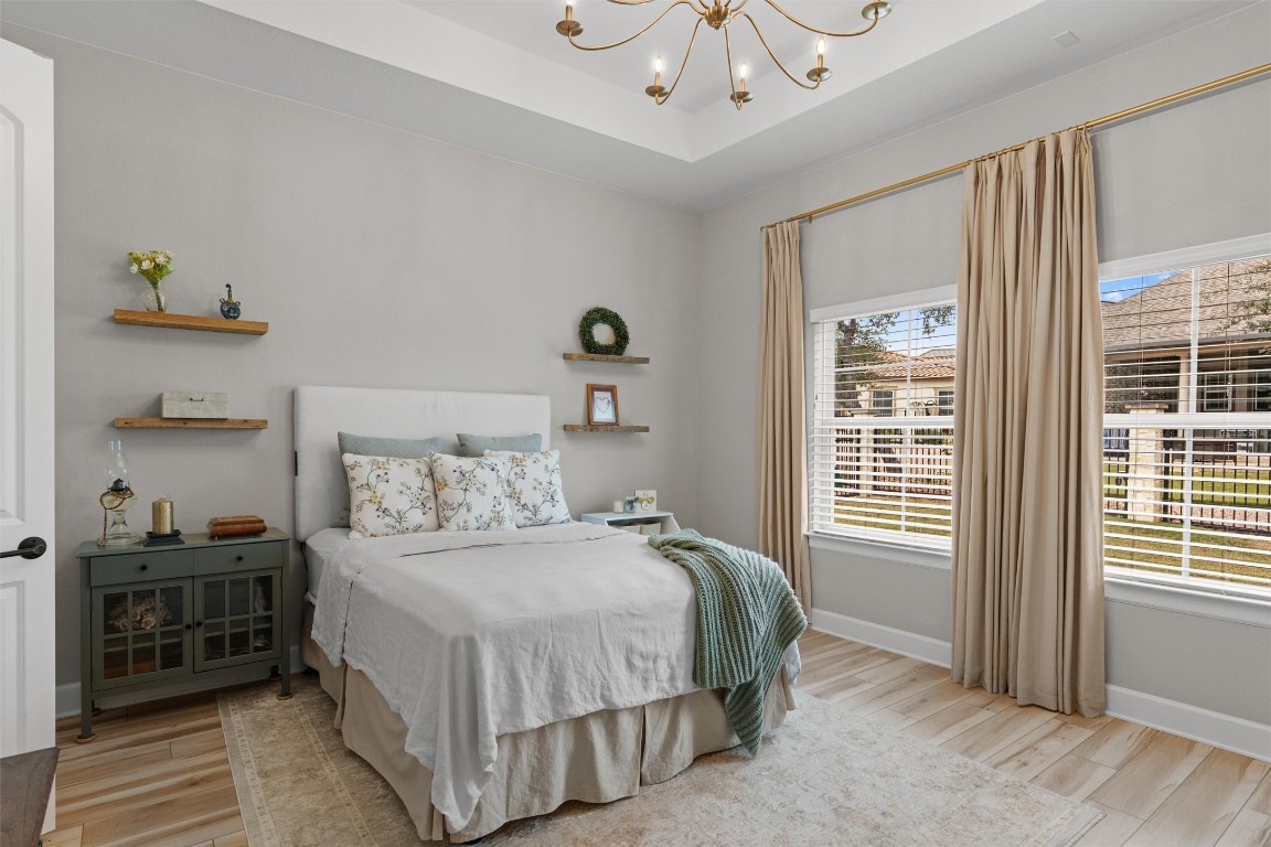 313 Racing Oak Loop San Marcos, TX 78666 - Photo 17 of 39 Primary bedroom is located at the rear of the home with beautiful windows overlooking the backyard. Luxury Vinyl Flooring is only 2 years old