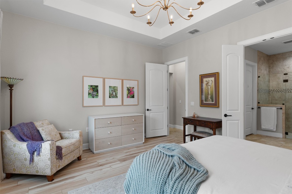 313 Racing Oak Loop San Marcos, TX 78666 - Photo 20 of 39 Another view of the primary bedroom showing the seating area and wall for furniture