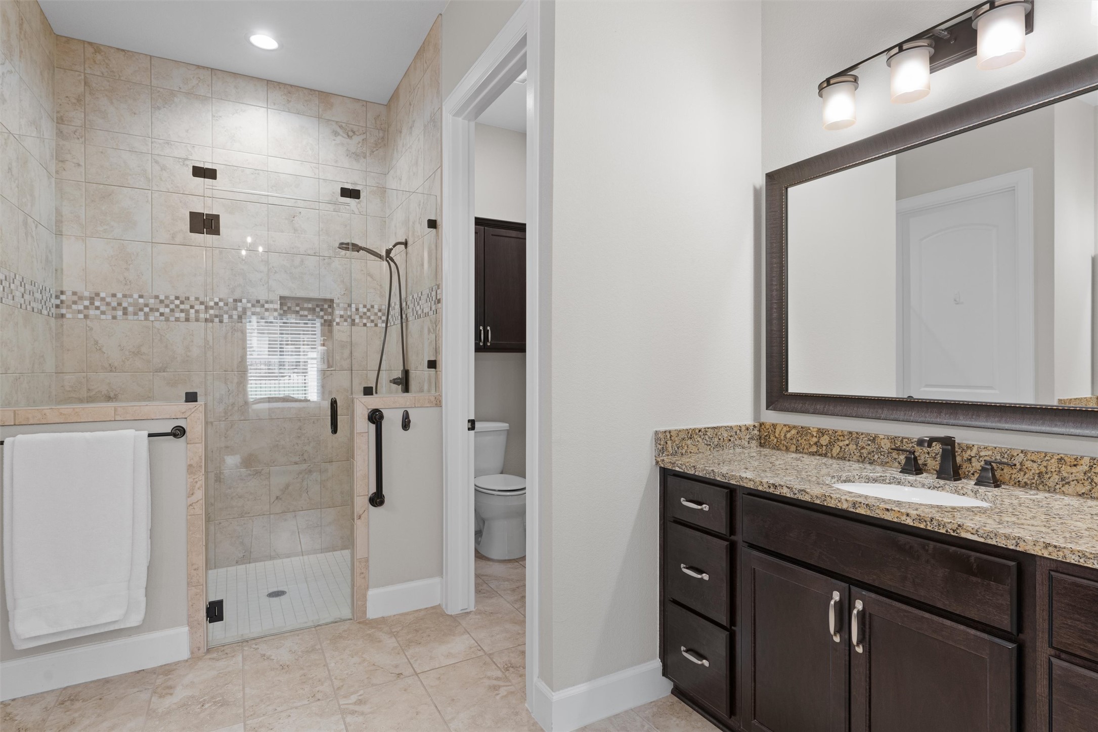 313 Racing Oak Loop San Marcos, TX 78666 - Photo 21 of 39 a bathroom with a granite countertop sink mirror and shower