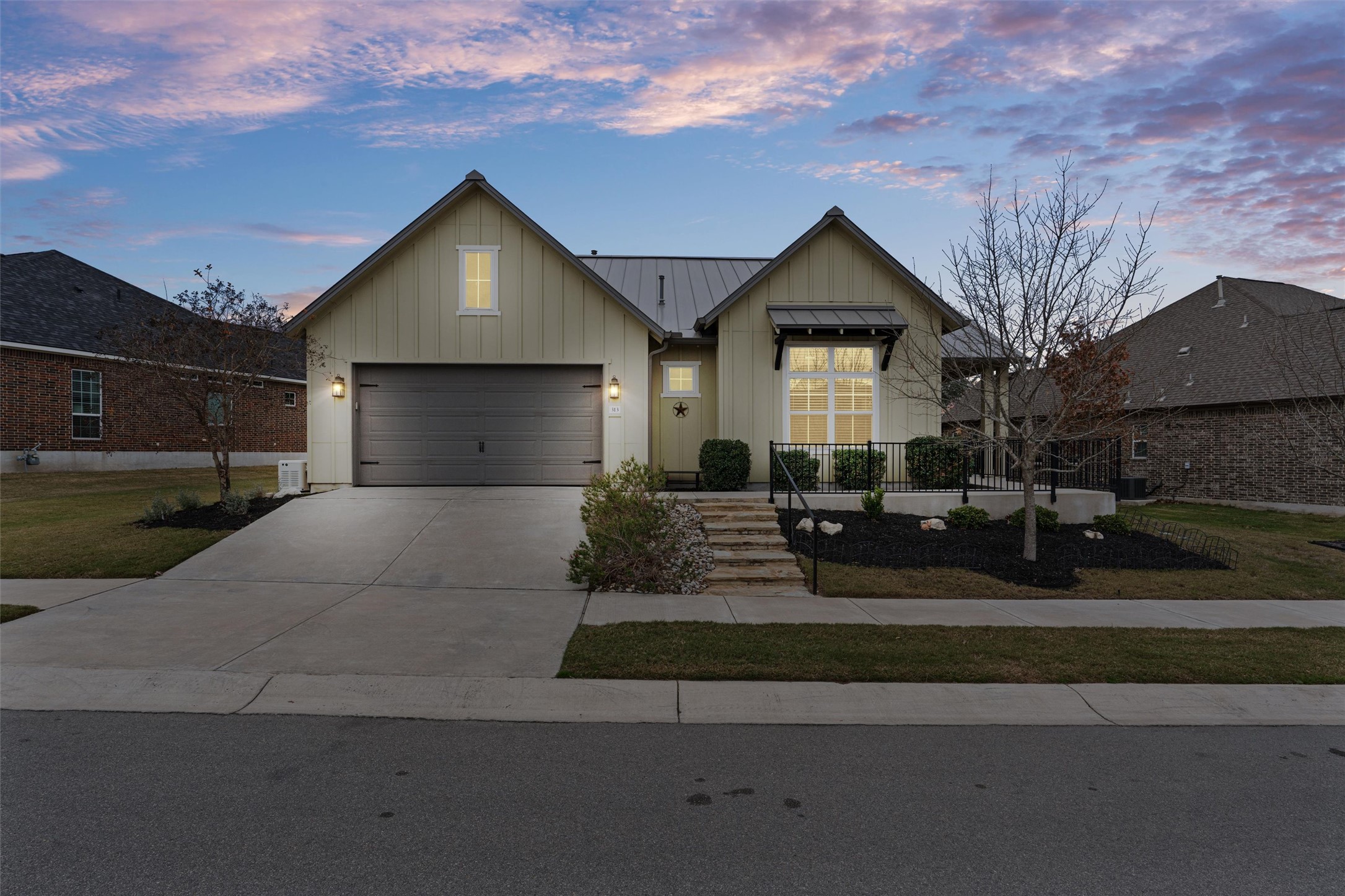 313 Racing Oak Loop San Marcos, TX 78666 - Photo 3 of 39 a front view of a house with a yard and garage
