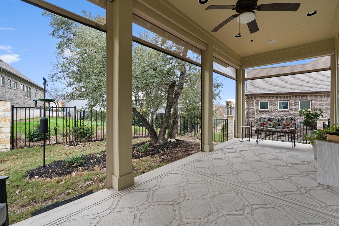 313 Racing Oak Loop San Marcos, TX 78666 - Photo 30 of 39 Another view of the patio with the automatic screens pulled up. This area is another entertaining area with views of the trees and yard.