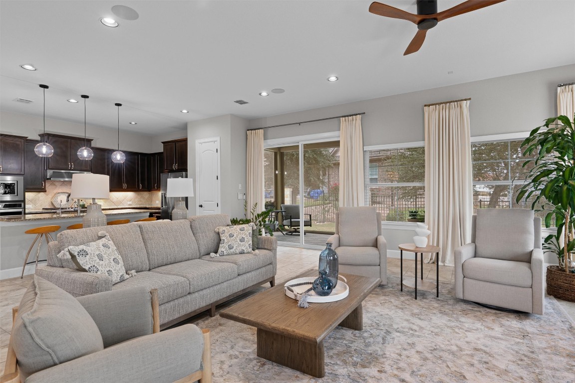 313 Racing Oak Loop San Marcos, TX 78666 - Photo 8 of 39 Large living room with lots of windows & sliding glass doors lead to the covered & screened patio.