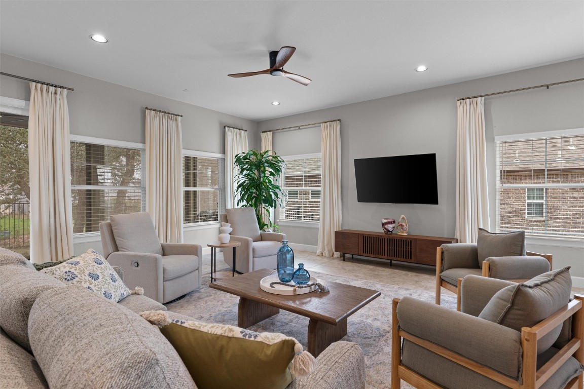 313 Racing Oak Loop San Marcos, TX 78666 - Photo 39 of 39 Check out all the space & large windows in the living room! The open floor plan has access to the kitchen and dining room.