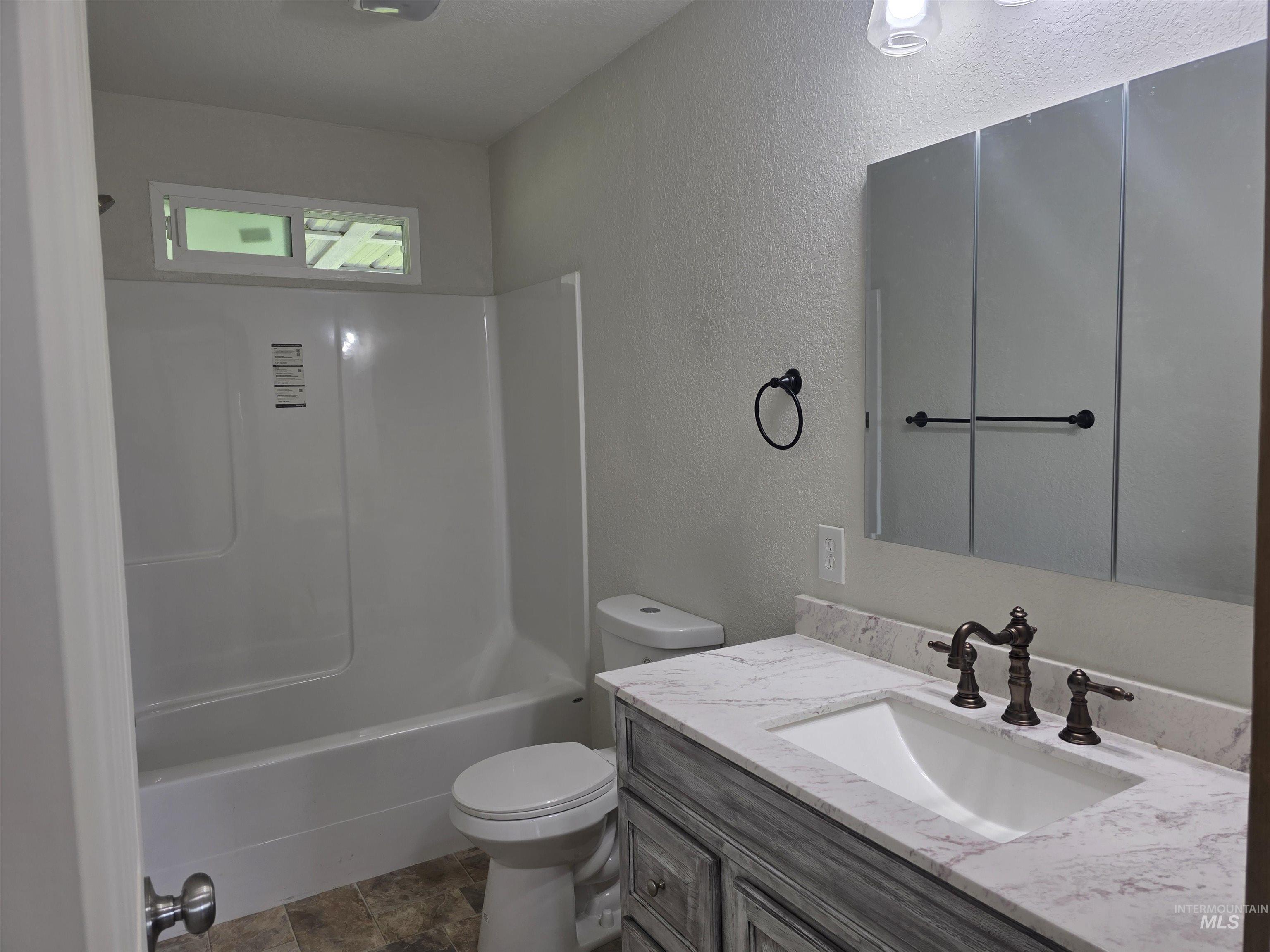 310 Fir Road Kamiah, ID 83536 - Photo 23 of 32 Bathroom featuring a single vanity with a stone countertop, an integrated sink, and an oil-rubbed bronze faucet