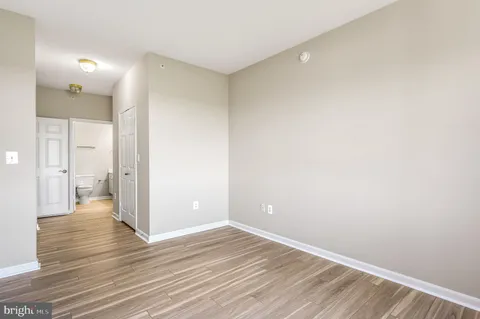 a view of a room with wooden floor