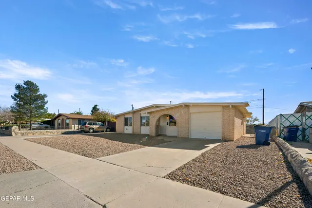 a view of a car park in front of a house
