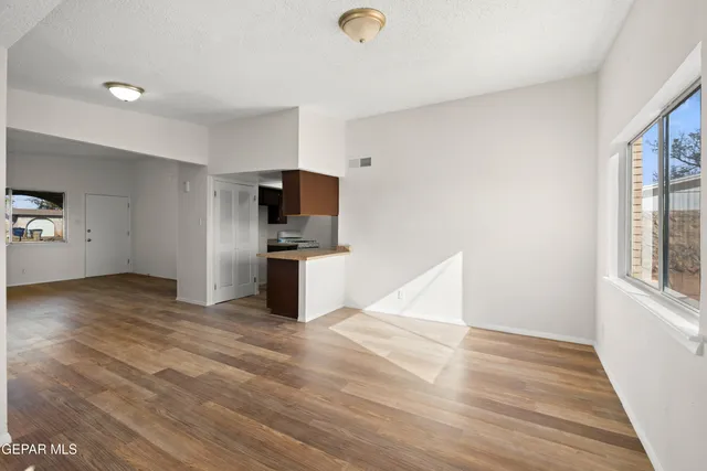 a view of a kitchen with wooden floor and electronic appliances