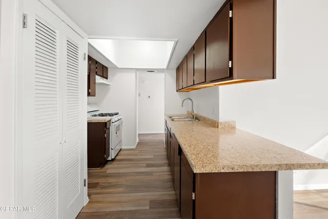 a kitchen with granite countertop a stove and cabinets