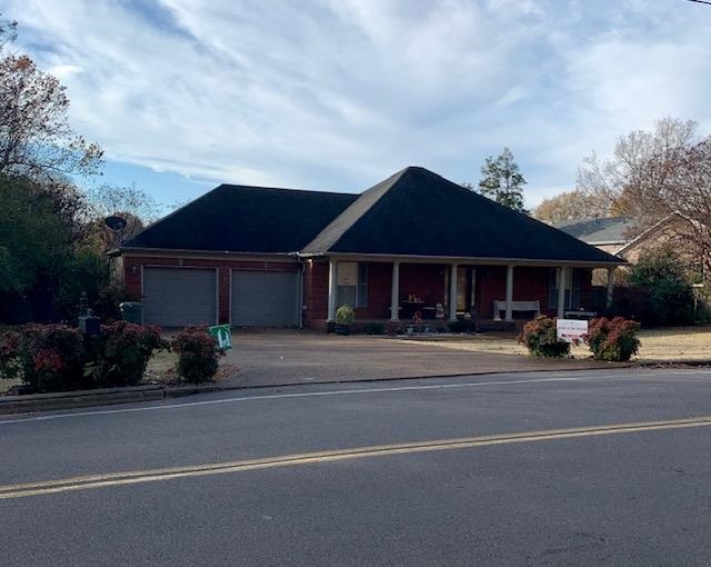 280 Church Street Ripley, TN 38063 - Photo 3 of 25 a front view of a house with a garden and pathway