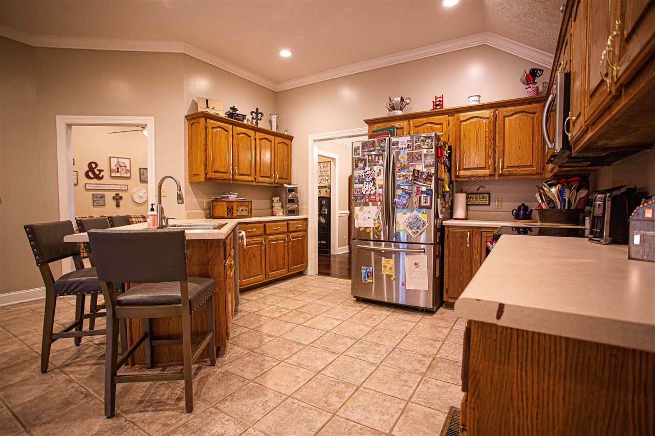 280 Church Street Ripley, TN 38063 - Photo 9 of 25 a kitchen with stainless steel appliances wooden floor and chairs