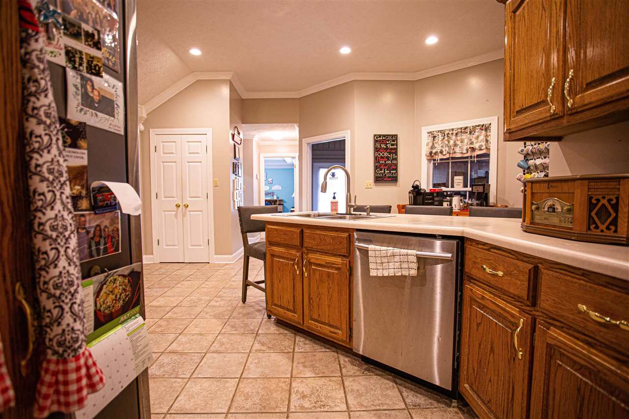 280 Church Street Ripley, TN 38063 - Photo 10 of 25 a kitchen with stainless steel appliances granite countertop a stove a sink and a microwave