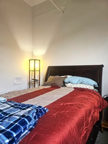 a bedroom with a bed and window