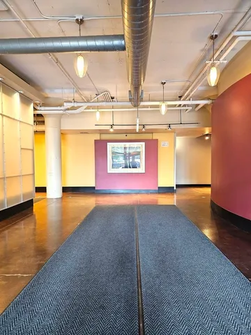 a view of a room with window & a wooden floor