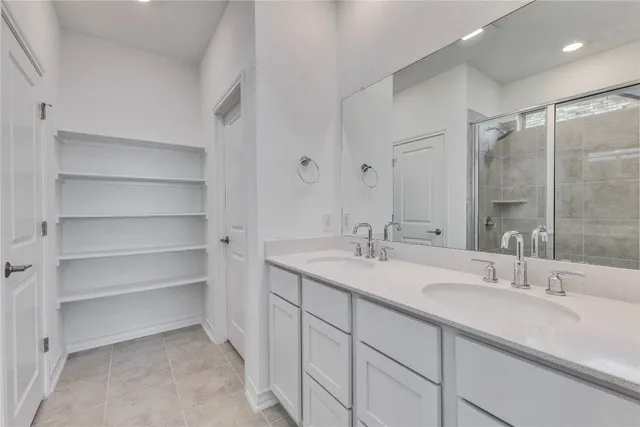 a bathroom with a sink double vanity and a mirror