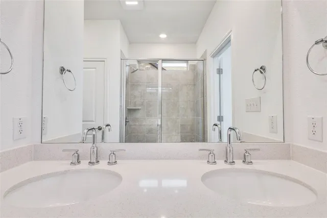 a bathroom with a double vanity sink mirror and double