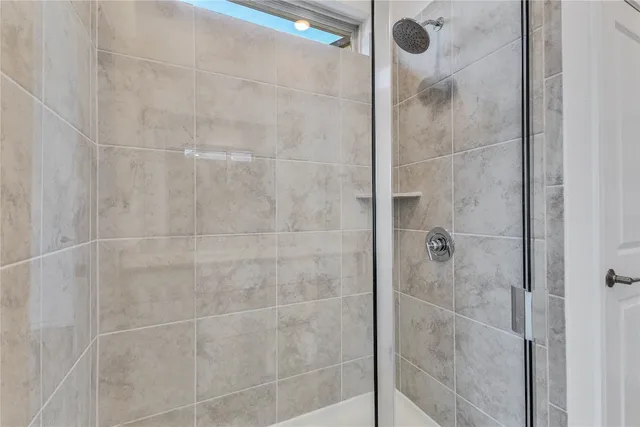 a bathroom with a glass shower door