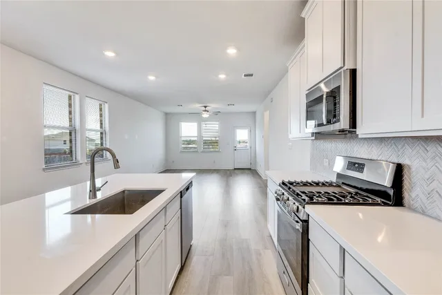 a kitchen that has a sink and a stove