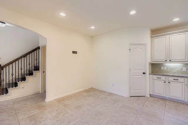 a view of a hallway with granite countertop stairs