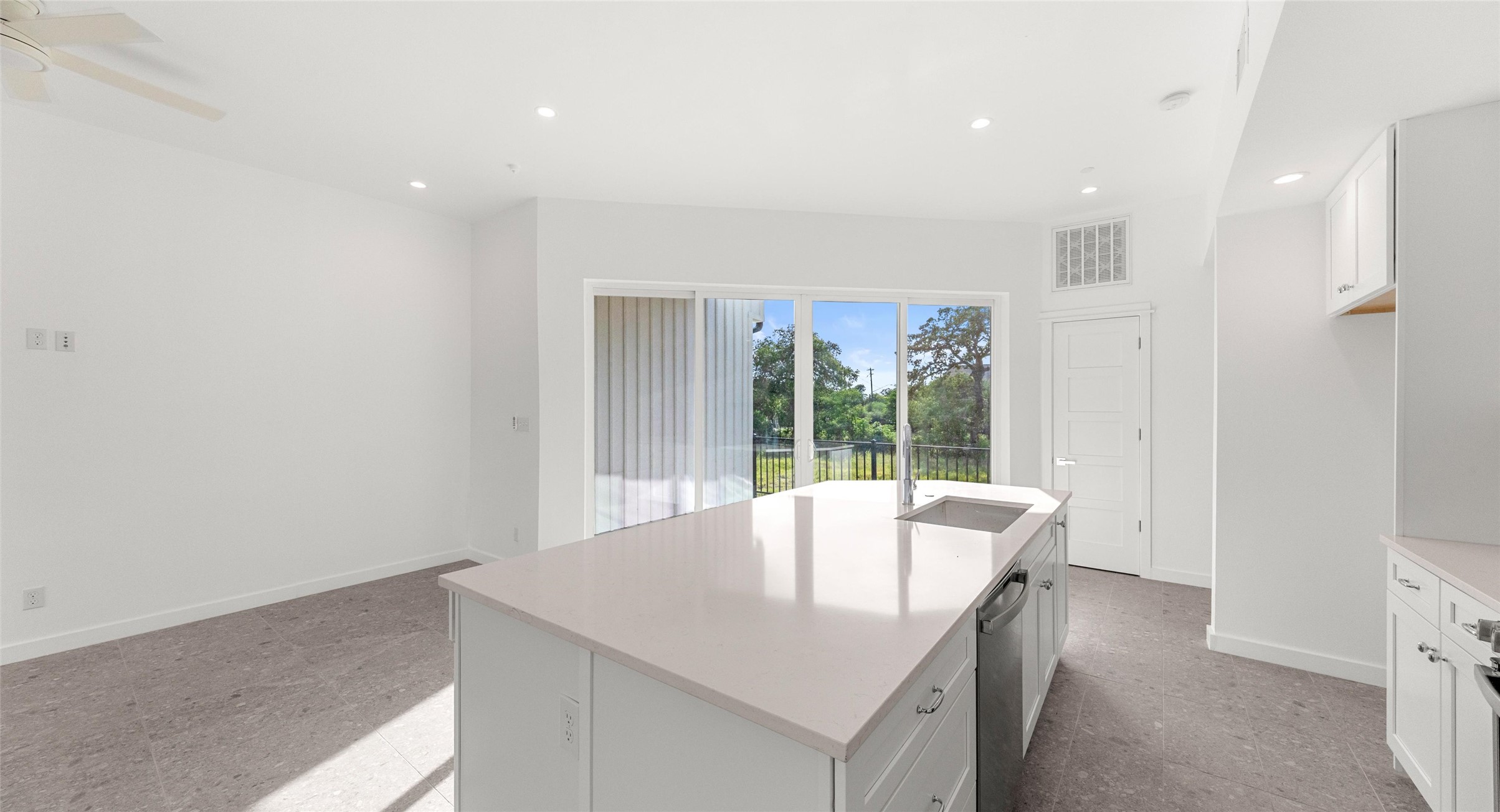 5912 Harold Court, Unit 106 Austin, TX 78721 - Photo 18 of 26 An open living and dining level wrapped in floor-to-ceiling glass, where natural light and easy flow make entertaining and relaxing equally effortless. Model No. 104 Shown.
