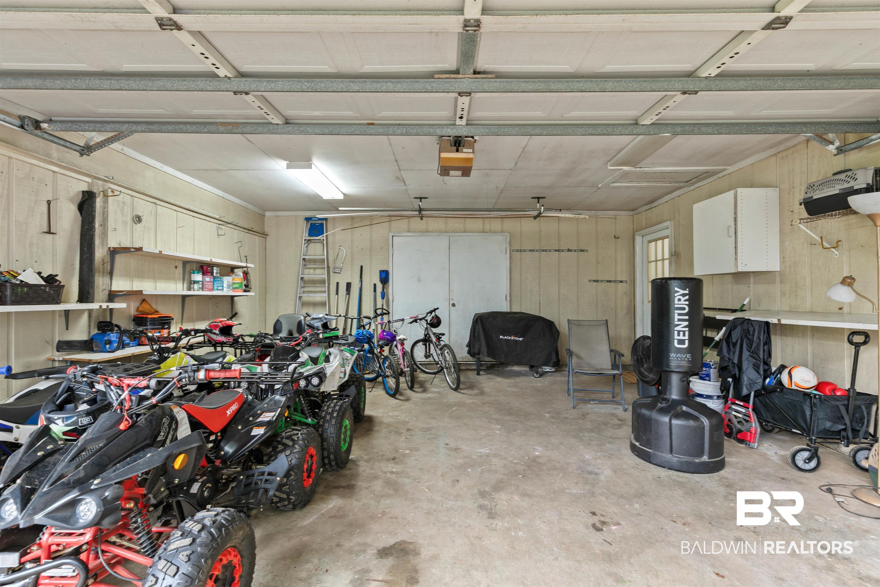 10420 Johnson Road South Mobile, AL 36695 - Photo 48 of 75 Spacious garage featuring concrete flooring, overhead lighting, and white paneling