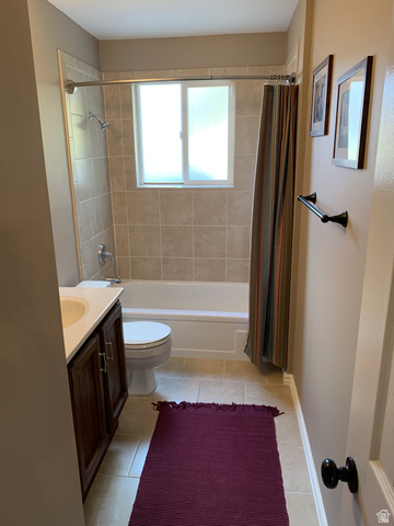 220 West Mill Road Ferron, UT 84523 - Photo 28 of 40 Bathroom featuring a white tub, light-colored wall tiling, a dark wood-finish vanity with a light countertop, and neutral floor tiling