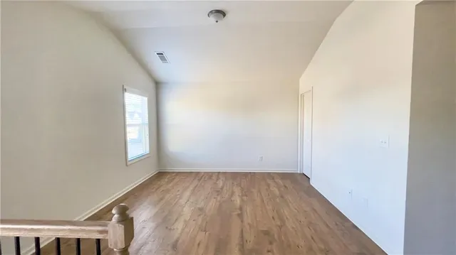 a view of room with window and hardwood floor
