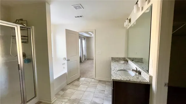 a room with a walk in closet and mirror