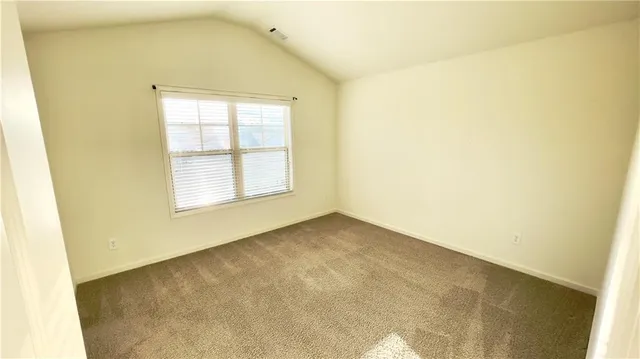 a view of an empty room and a window