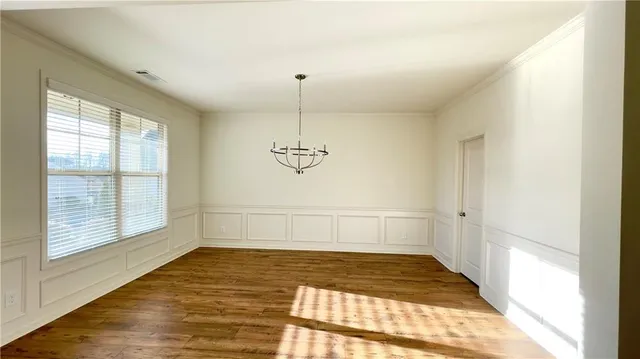a view of a room with window and chandelier fan