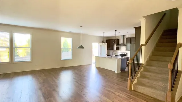 a view of kitchen with sink and refrigerator