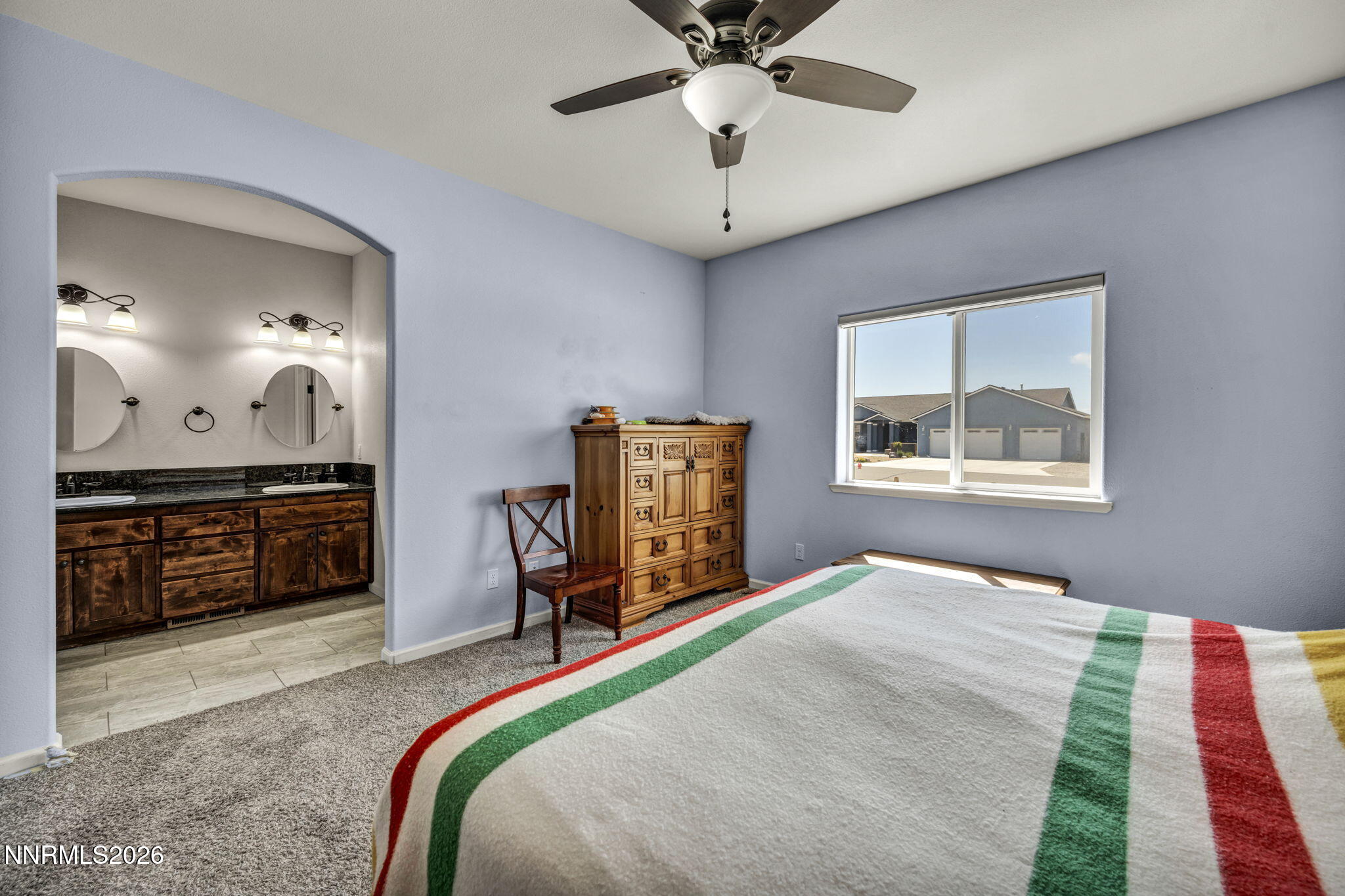 1286 Sky Ridge Drive Fallon, NV 89406 - Photo 23 of 49 a bedroom with a bed and a chandelier