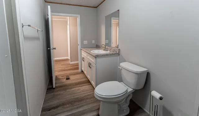a bathroom with a toilet a sink and a mirror
