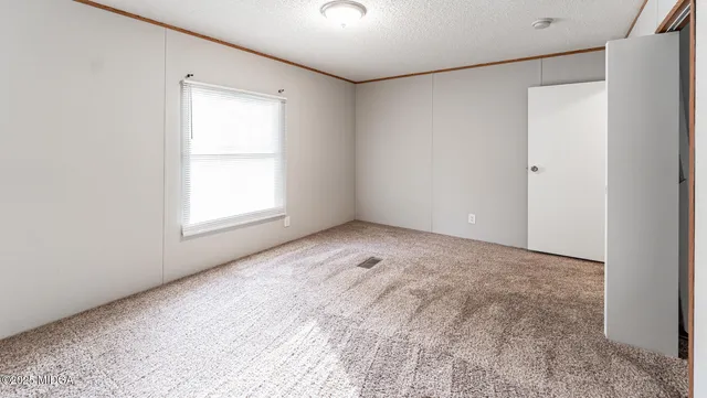 an empty room with windows and closet