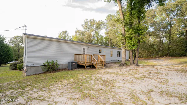 a backyard of a house with yard and seating area