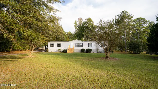 a front view of a house with a big yard