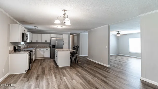 a kitchen with a refrigerator a stove top oven a sink and dishwasher
