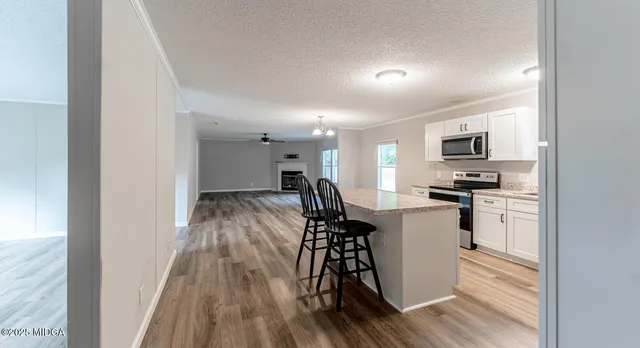 a view of a kitchen with microwave and stove