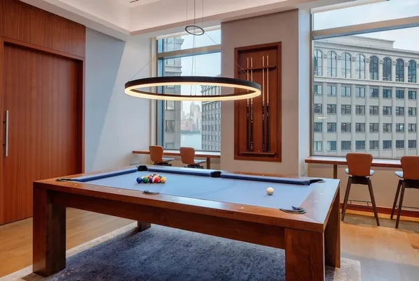a room with furniture pool table table tennis table and chairs