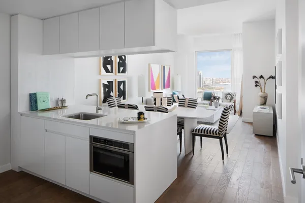 a kitchen with a sink cabinets and wooden floor