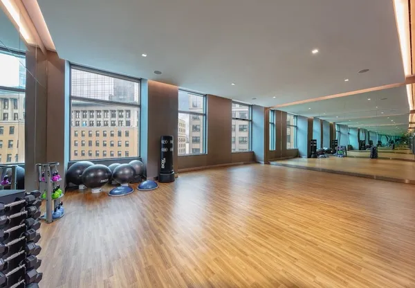 a living room with furniture wooden floor and a large window