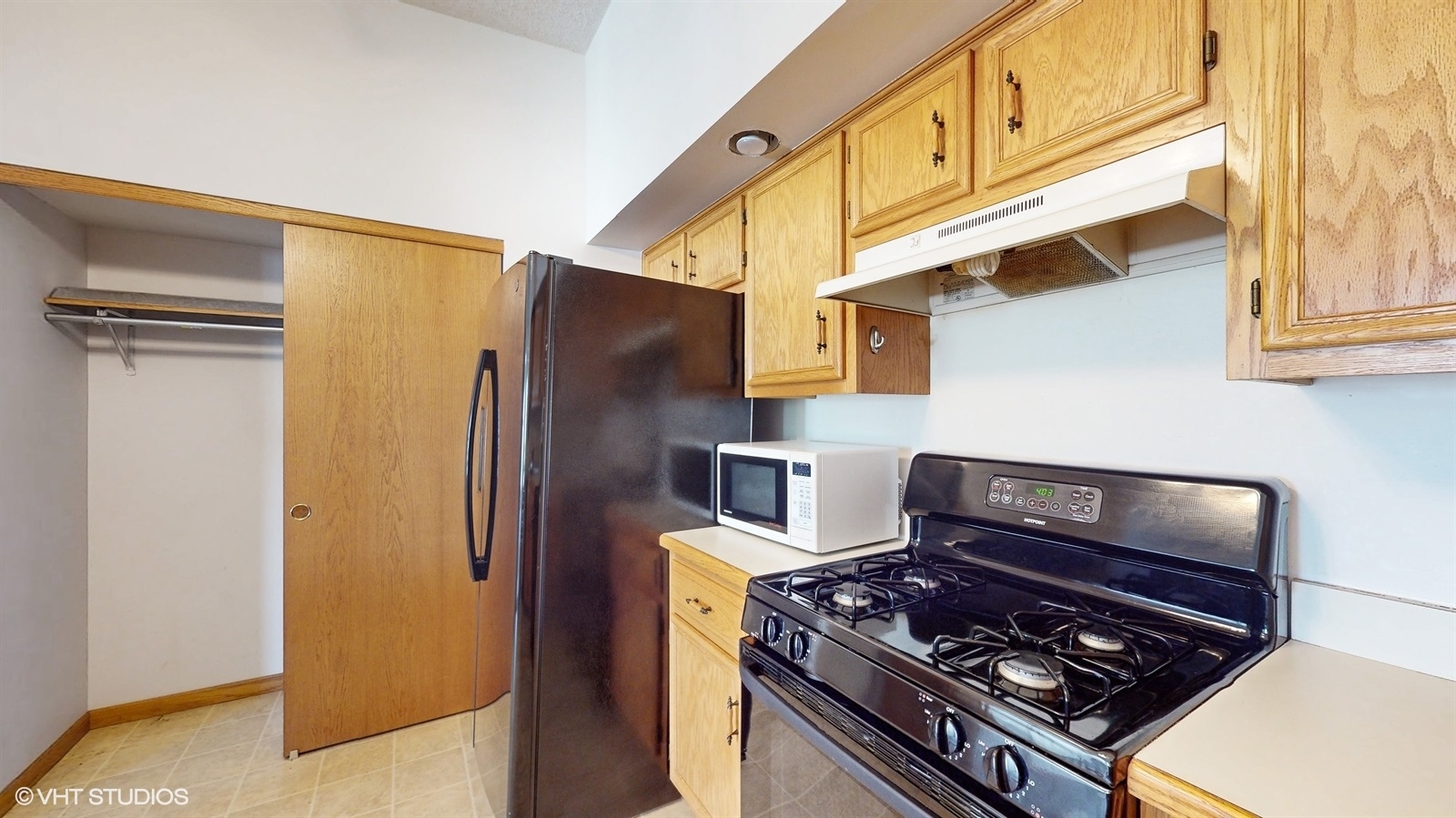 2851 West Heritage Drive, Unit 2C Joliet, IL 60435 - Photo 11 of 23 a kitchen with stainless steel appliances granite countertop a stove and a refrigerator