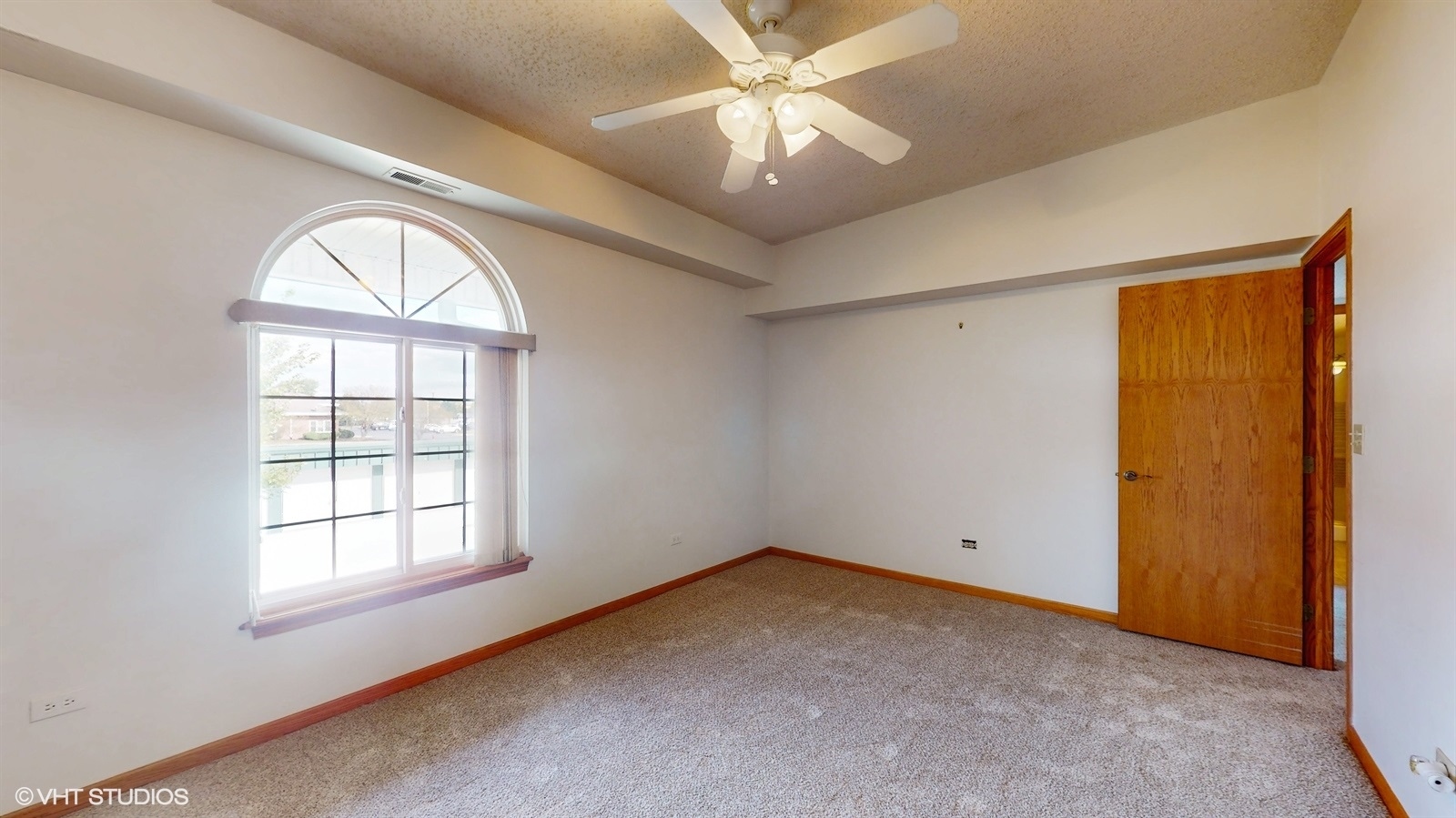 2851 West Heritage Drive, Unit 2C Joliet, IL 60435 - Photo 12 of 23 an empty room with a window and a ceiling fan