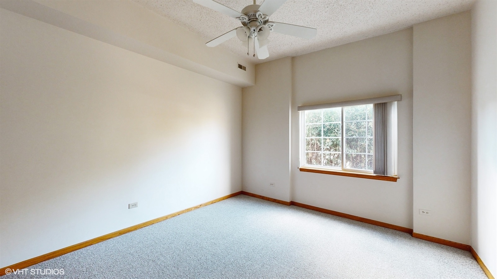 2851 West Heritage Drive, Unit 2C Joliet, IL 60435 - Photo 15 of 23 an empty room with a chandelier fan and windows