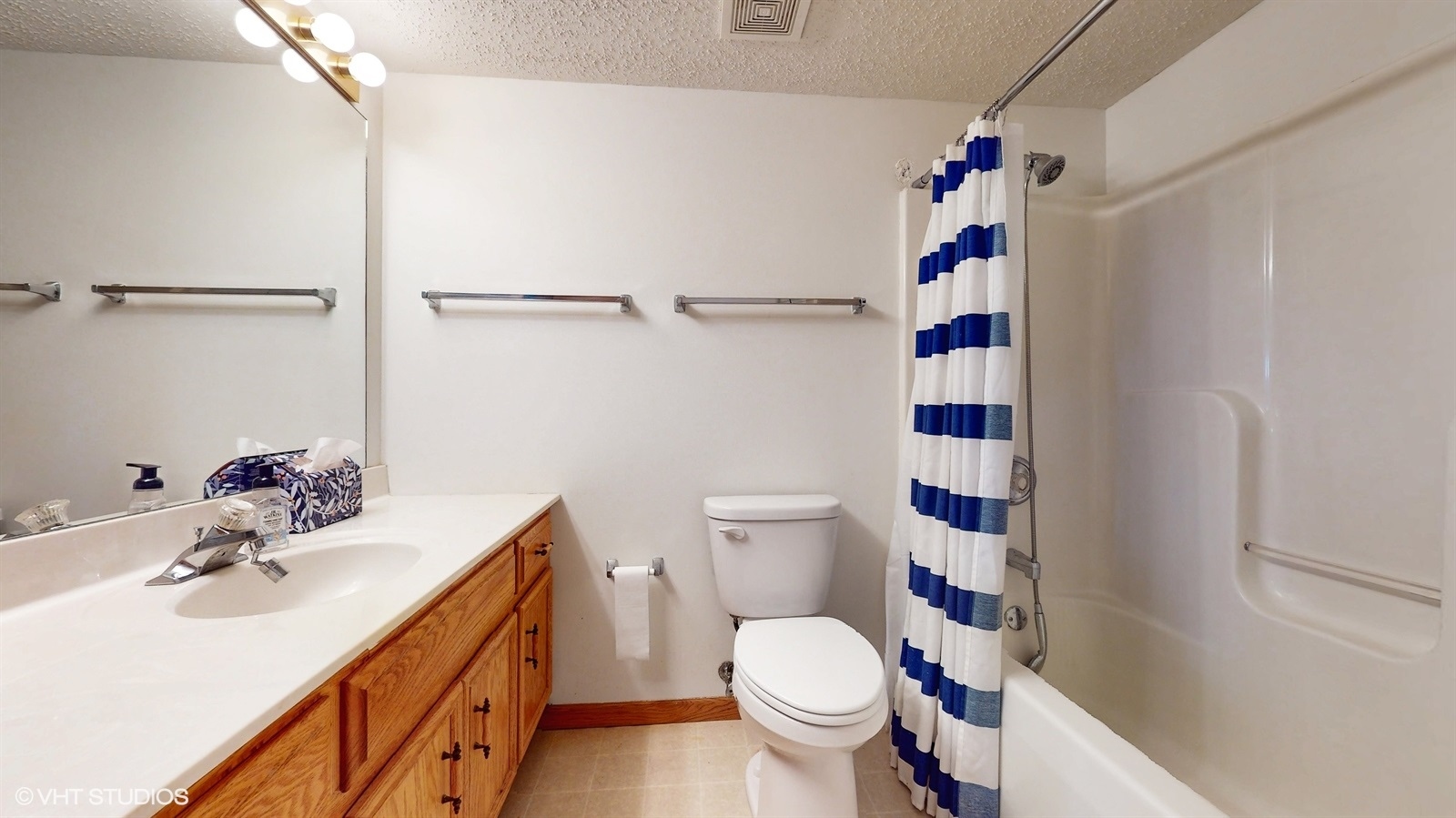 2851 West Heritage Drive, Unit 2C Joliet, IL 60435 - Photo 16 of 23 a bathroom with a sink a toilet and shower curtain