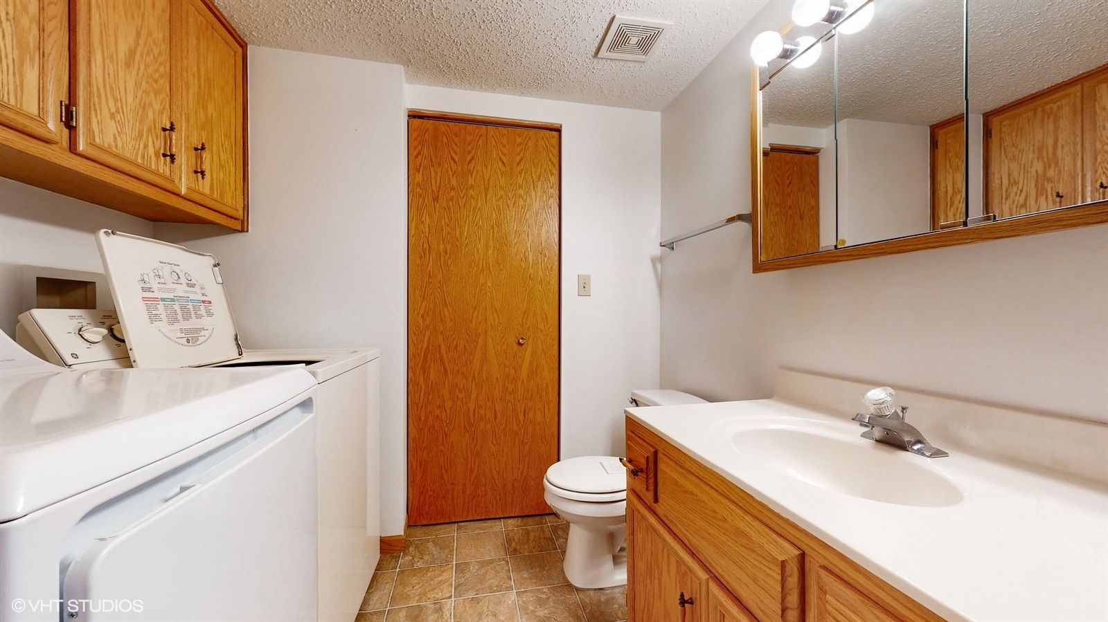 2851 West Heritage Drive, Unit 2C Joliet, IL 60435 - Photo 18 of 23 a bathroom with a sink a toilet and mirror