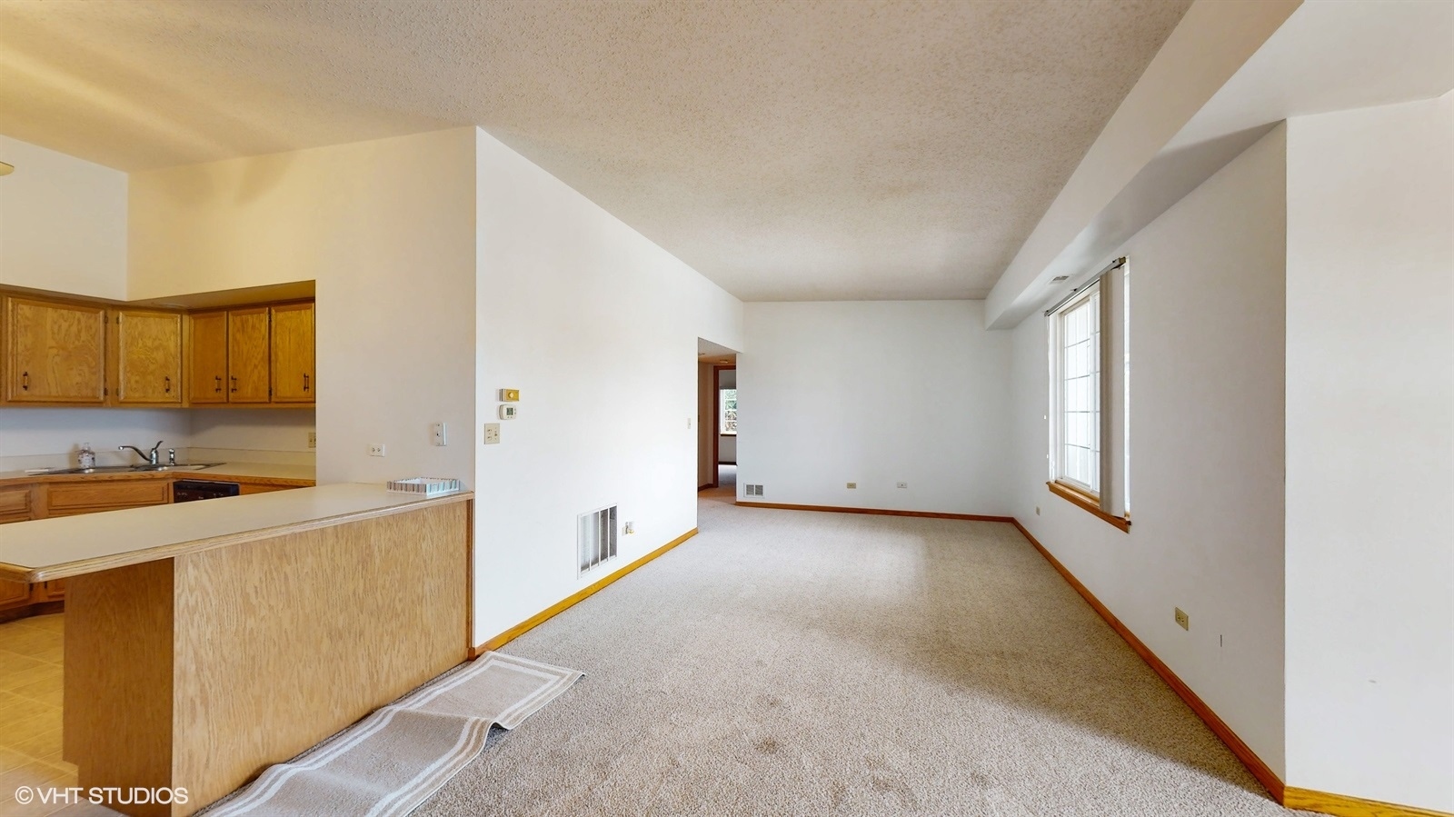2851 West Heritage Drive, Unit 2C Joliet, IL 60435 - Photo 5 of 23 a view of a kitchen with a sink and dishwasher a refrigerator with white cabinets