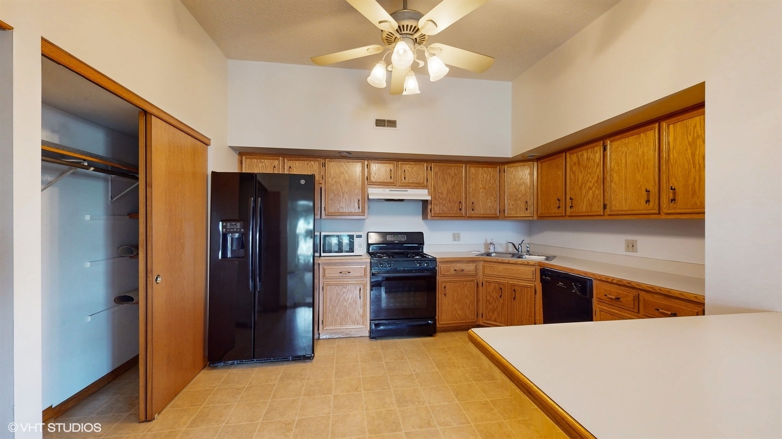 2851 West Heritage Drive, Unit 2C Joliet, IL 60435 - Photo 9 of 23 a kitchen with a refrigerator a stove top oven a sink and dishwasher